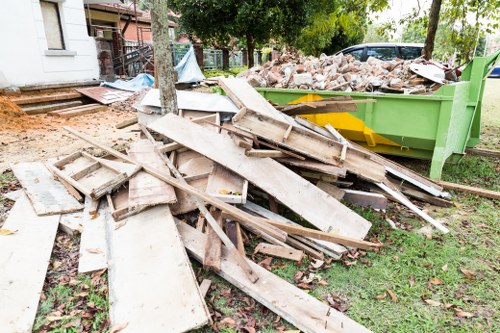 Demolition site with waste removal equipment in Hoxton
